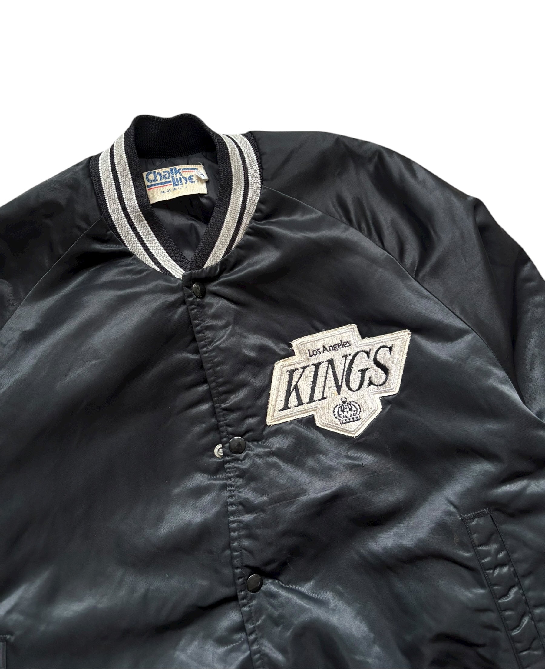 Black jacket with 'Los Angeles Kings' logo on a white background